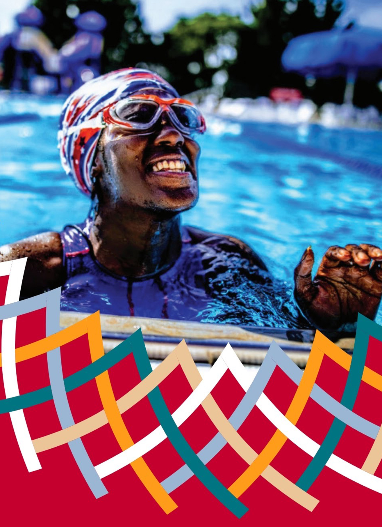 Smiling Ashton Smith, climbing out of the pool, wearing a red USA cap, blue suit, and goggles.